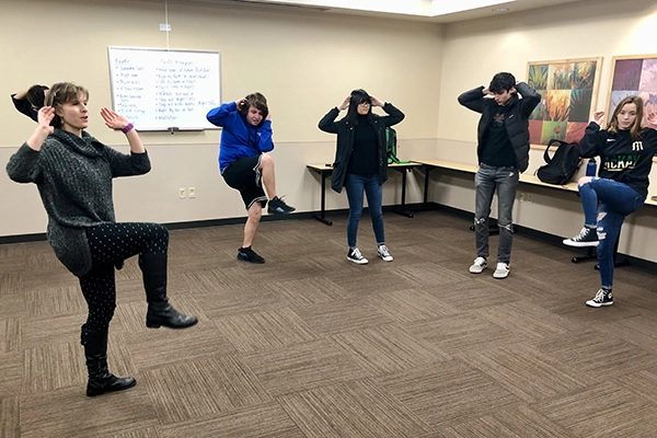 Salem Health educator leads mindful movement class with teenagers.
