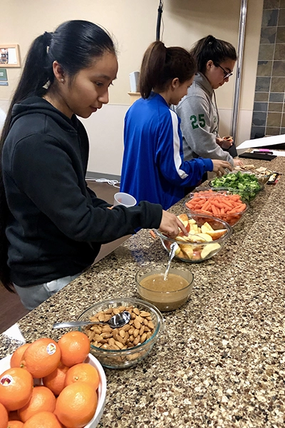 Teenagers making healthy food choices at Salem Health wellness event.