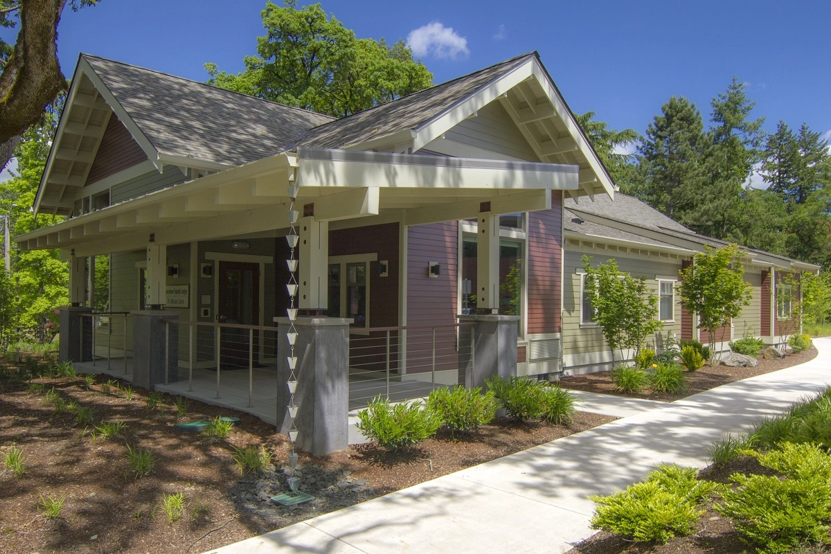 An exterior view of the Parkview Family Lodge, a craftsman-style house painted in shades of red, green and tan.
